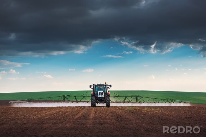 Tableau  Farming tractor plowing and spraying on field