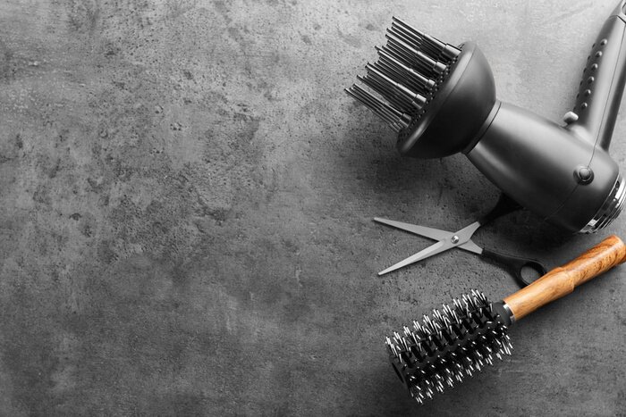 Tableau  Flat lay composition with set of hairdresser's tools on grey background