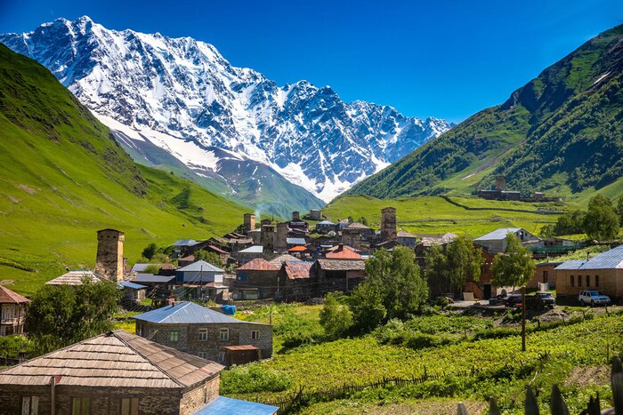 Tableau  Georgian Village Ushguli with stone defense towers in a valley next to the river in Svaneti region near Mestia in Caucasus mountains in Georgia.