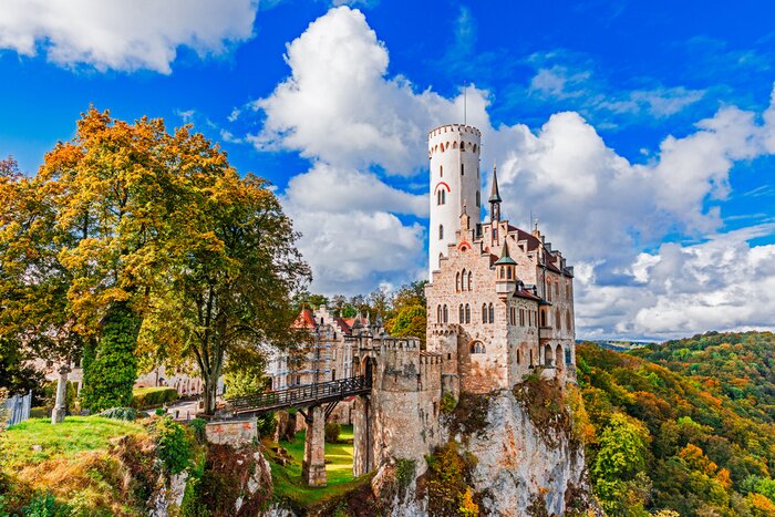 Tableau  Germany, Lichtenstein Castle in Baden-Wurttemberg land in Swabian Alps. Seasonal view of Lichtenstein Castle on a cliff circled by trees with yellow foliage. European famous landmark.
