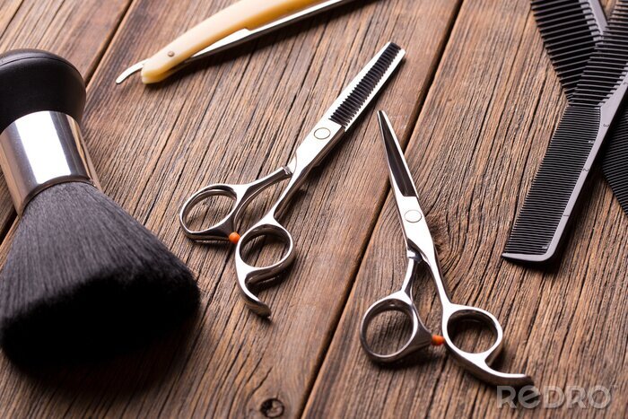 Tableau  Hairdressing tool kit. Scissors and other tool barber. Barber set. Barber tool on a wooden table. Scissors, comb for hair and a razor close-up.