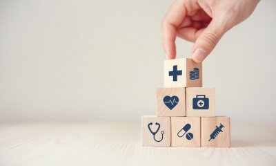 Tableau  Health Insurance Concept, Hand arranging wood cube stacking with icon healthcare medical on wood background, copy space, financial concept.
