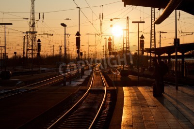 Tableau  Hiver coucher de soleil sur la gare de Karlsruhe avec des personnes en attente d'un train