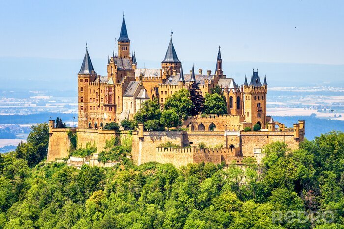 Tableau  Hohenzollern Castle close-up, Germany. This fairytale castle is famous landmark near Stuttgart. Scenic view of mount Burg Hohenzollern in forest. Scenery of Swabian Alps with Gothic castle in summer.