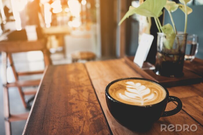 Tableau  Latte cup on wooden table blur coffee shop background