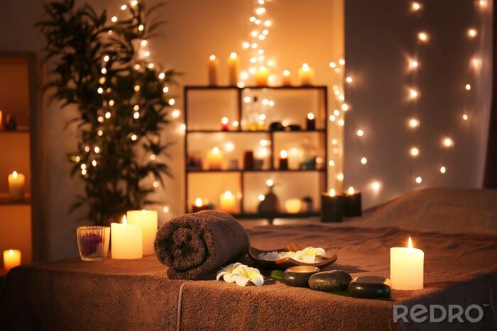 Tableau  Massage stones with towel and candles on table in spa salon
