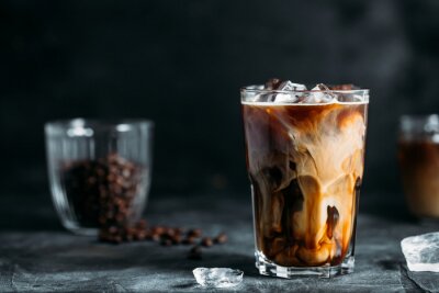 Tableau  Milk Being Poured Into Iced Coffee on a dark table