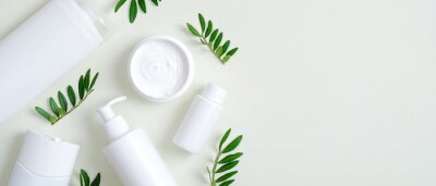 Tableau  Natural organic SPA cosmetic products set with green leaves. Top view herbal skincare beauty products on green background. Banner mockup for eco shop or beauty salon. Flat lay minimalist style