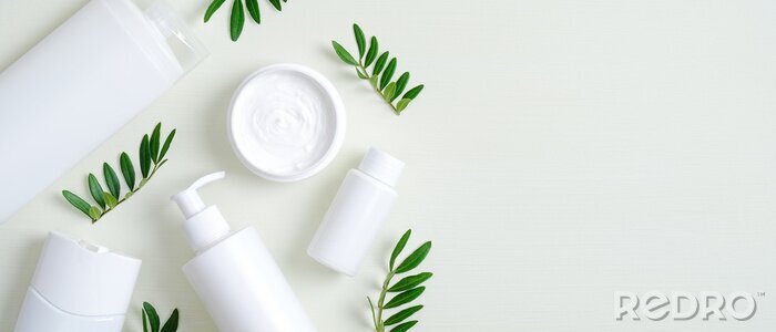 Tableau  Natural organic SPA cosmetic products set with green leaves. Top view herbal skincare beauty products on green background. Banner mockup for eco shop or beauty salon. Flat lay minimalist style