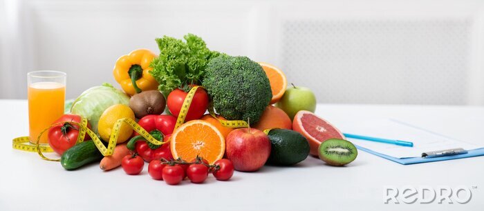 Tableau  Nutritionist's workplace with fruits, vegetables, measuring tape on table