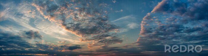 Tableau  Panorama evening sky with blue, white and orange clouds