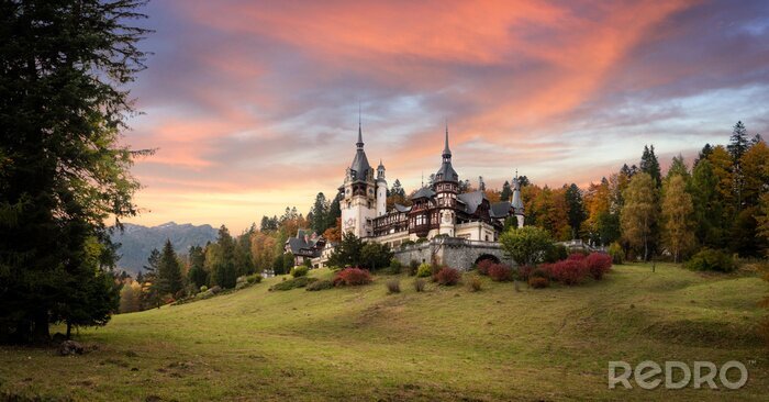 Tableau  Panorama of Peles Castle, Romania. Beautiful famous royal castle and ornamental garden in Sinaia landmark of Carpathian Mountains in Europe at sunset. Former Home Of The Romanian Royal Family. 