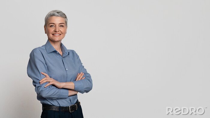 Tableau  Portrait Of Mature Businesswoman Posing With Folded Arms Over Light Background