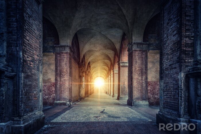 Tableau  Rays of divine light illuminate old arches and columns of ancient buildings. Bologna, Italy. Conceptual image on historical, religious and travel theme.