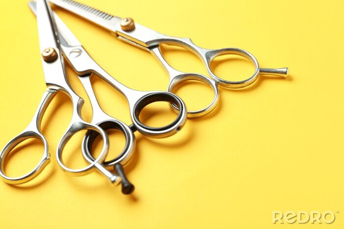 Tableau  Scissors and space for text on color background, closeup. Hairdresser tools