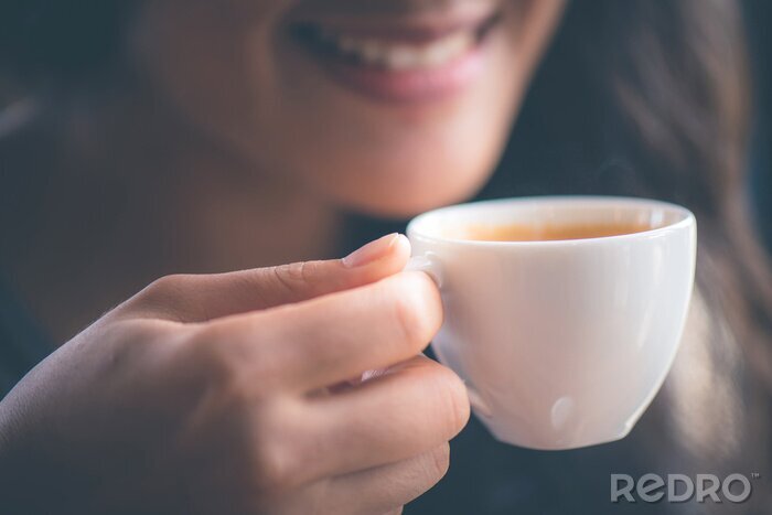 Tableau  Smiling woman holing hot espresso coffee on hand at cafe in the morning