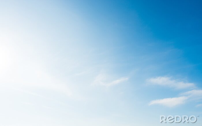 Tableau  Soft blue sky with small white clouds and bright sun light