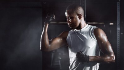Tableau  sport portrait of african american athletics strong bodybuilder man posing show his muscle in gym in dark tone