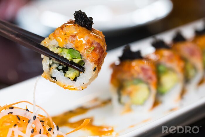 Tableau  Sushi roll with black chopsticks