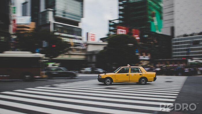 Tableau  Taxi speeding across Shibuya crossing in Tokyo Japan