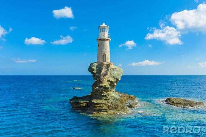 Tableau  The beautiful Lighthouse Tourlitis of Chora in Andros island and a seagull, Cyclades, Greece
