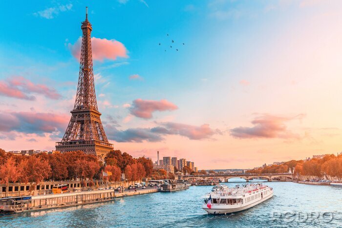 Tableau  The main attraction of Paris and all of Europe is the Eiffel tower in the rays of the setting sun on the bank of Seine river with cruise tourist ships
