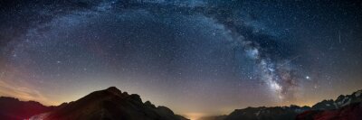 Tableau  The Milky Way arch starry sky on the Alps, Massif des Ecrins, Briancon Serre Chevalier ski resort, France. Panoramic view high mountain range and glaciers, astro photography, stargazing