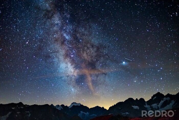 Tableau  The Milky Way arch starry sky on the Alps, Massif des Ecrins, Briancon Serre Chevalier ski resort, France. Panoramic view high mountain range and glaciers, astro photography, stargazing