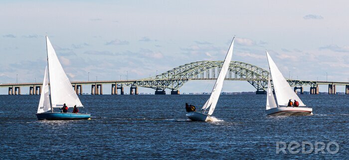 Tableau  Three two person sailboats in front of the Great South Bay bridge on a windy December afternoon