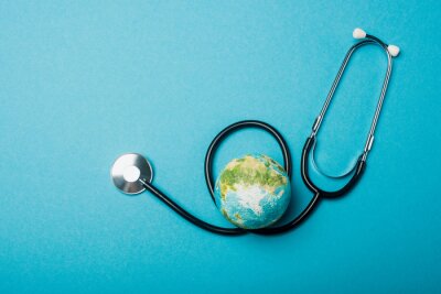 Tableau  Top view of globe and stethoscope on blue background, world health day concept