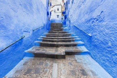Tableau  Traditional typical moroccan architectural details in Chefchaouen, Morocco, Africa Beautiful street of blue medina with blue walls and decorated with various objects (pots, jugs). A city with narrow, 