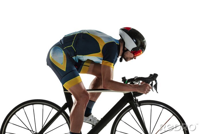 Tableau  Triathlon male athlete cycle training isolated on white studio background. Caucasian fit triathlete practicing in cycling wearing sports equipment. Concept of healthy lifestyle, sport, action, motion.