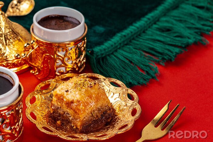 Tableau  Turkish baklava and coffee in oriental dishware on red background