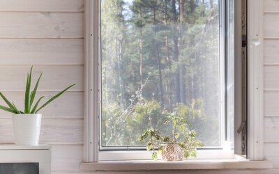 Tableau  White window with mosquito net in a rustic wooden house overlooking the garden.